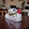 Custom baseball-themed Nike Air Force 1 sneakers with gold and red accents.