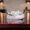 Custom baseball-themed Nike Air Force 1 sneakers with gold swoosh and red baseball stitching details.