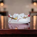 KicksInk Personalized Baseball Air Force 1 Sneakers Custom baseball-themed Nike Air Force 1 sneakers with gold swoosh and red baseball stitching details.