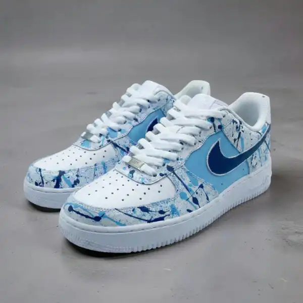 Air Force 1 sneakers with blue splash paint design, hand-painted for a unique look.