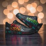 Custom graffiti design Air Force 1 sneakers in black with colorful street art details.