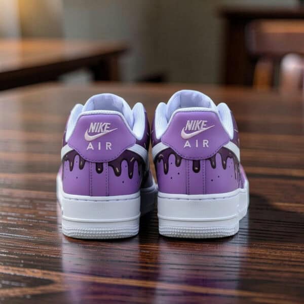 Hand-painted purple Ice Cream Drip Nike Air Force 1 sneakers on wooden table.