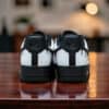 Custom white drip Air Force 1 sneakers with black accents and unique design details.