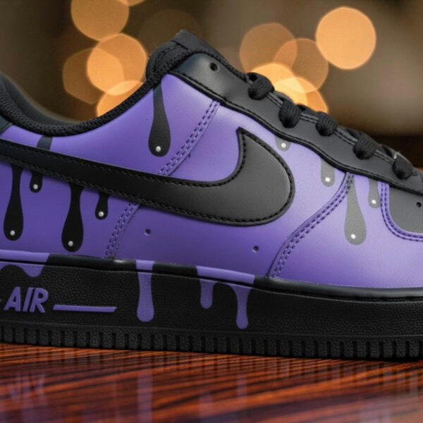 Custom purple drip Air Force 1 sneakers with black accents and unique design.