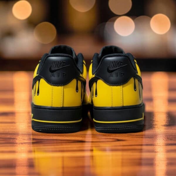 Custom yellow drip Air Force 1 sneakers with black accents, stylish and unique footwear.