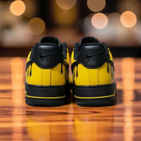 Custom yellow drip Air Force 1 sneakers with black accents, stylish and unique footwear.