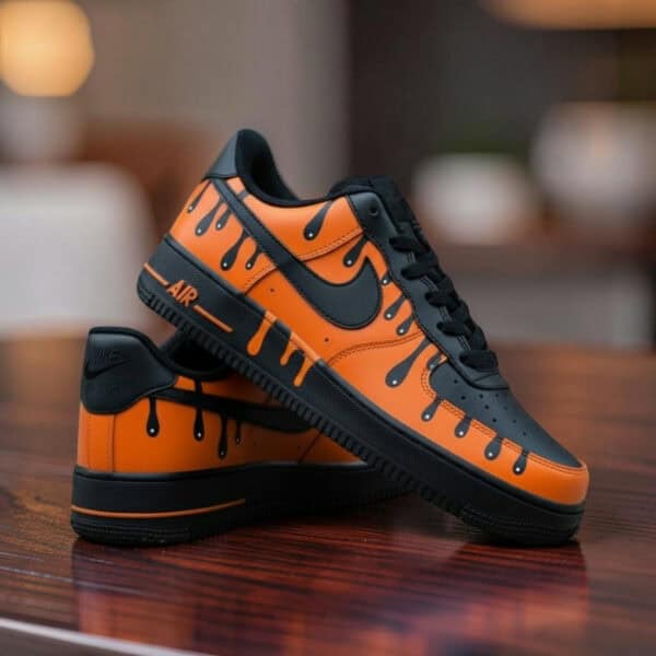 Custom orange drip Air Force 1 sneakers with black accents and unique design.