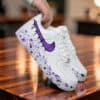 Air Force 1 sneakers with purple drip design and paint splatter on the sole, perfect for custom snea.