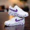 Custom purple drip Nike Air Force 1 sneakers with paint splatter design. Perfect for streetwear and.