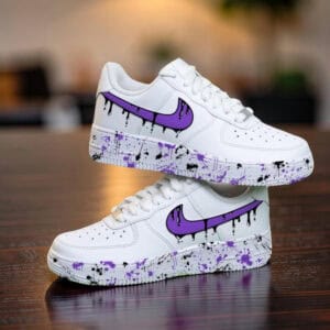 Custom purple drip Nike Air Force 1 sneakers with paint splatter design. Perfect for streetwear and.
