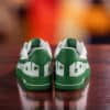 Custom green drip Nike Air Force 1 sneakers with shamrock accents for St. Patrick's Day.