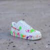 Hand-Painted Splash Air Force 1 sneakers featuring vibrant, multicolored paint splatters on a white.