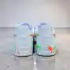 Custom hand-painted splash design on white Nike Air Force 1 sneakers.