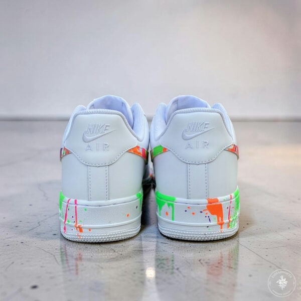 Custom hand-painted splash design on white Nike Air Force 1 sneakers.