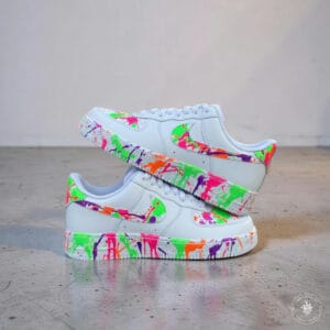 Colorful hand-painted splash design on white Air Force 1 sneakers for a bold streetwear look.