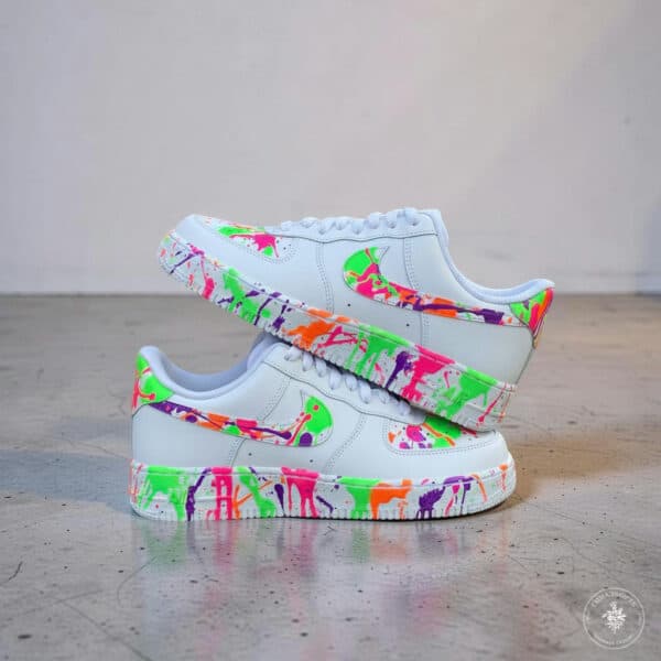 Colorful hand-painted splash design on white Air Force 1 sneakers for a bold streetwear look.