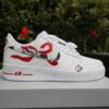 Custom painted white Nike Air Force 1 sneakers featuring a red anime character design.