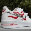 Custom painted red anime lips and teeth design on white Nike Air Force 1 sneakers.