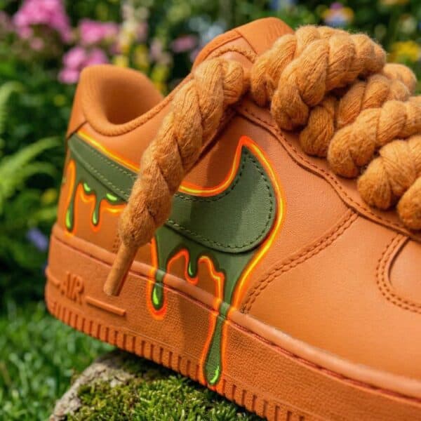 Hand-painted orange and green drip design on custom Air Force 1 sneakers. Unique, vibrant, and artis.
