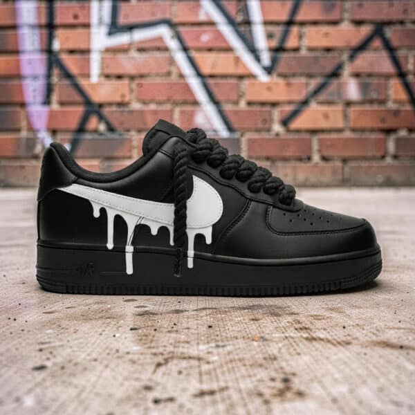 Black Air Force 1 sneakers with white drip paint design, custom hand-painted for a unique look.