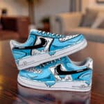 Hand-Painted Blue Cartoon Drip AF1 Sneakers Custom hand-painted blue cartoon drip Nike Air Force 1 sneakers on wooden table.