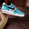 Custom painted blue cartoon drip Nike Air Force 1 sneakers for unique streetwear style.