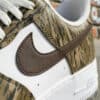 Close-up of hand-painted duck camo design on Nike Air Force 1 sneakers.