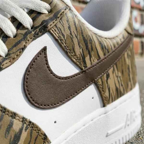 Close-up of hand-painted duck camo design on Nike Air Force 1 sneakers.