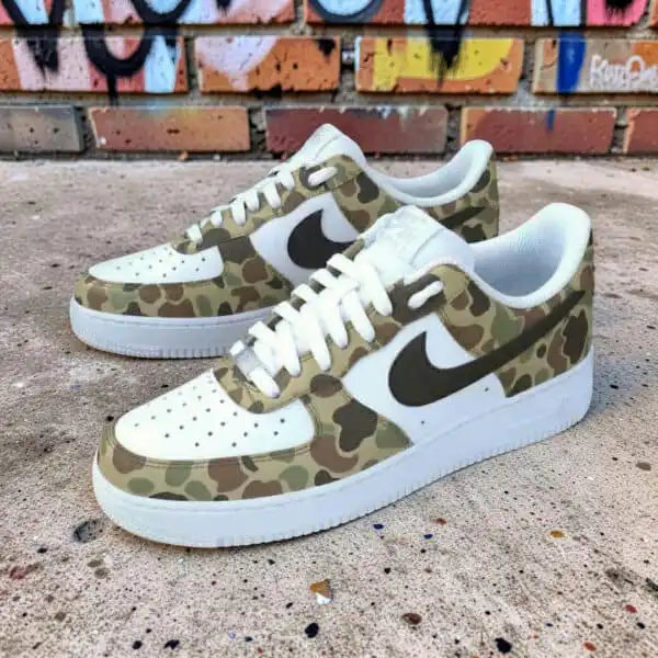 Air Force 1 sneakers with hand-painted camouflage design and Nike swoosh. Unique custom sneakers for.