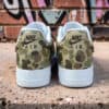 Hand-painted camouflage Nike Air Force 1 sneakers with detailed design.