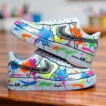 Custom hand-painted splash art on Air Force 1 sneakers with vibrant, multicolor paint splatters and.