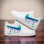 Custom hand-painted blue jade drip design on white Air Force 1 sneakers.