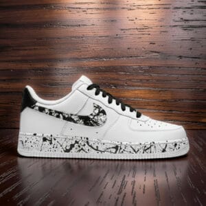 Hand-painted black splash design on white Air Force 1 sneakers with black accents.
