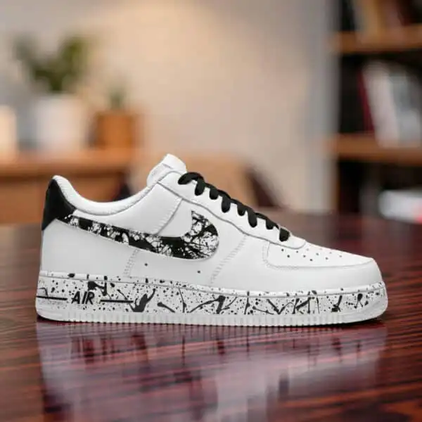 Custom hand-painted black splash design on white Air Force 1 sneakers.