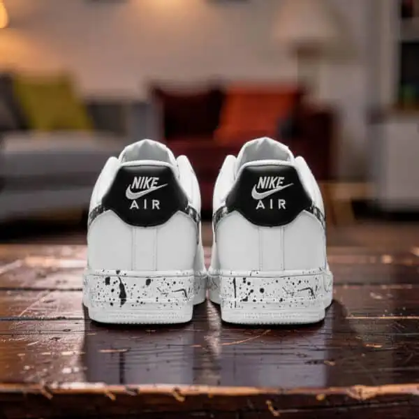 Custom black splash design on white Nike Air Force 1 sneakers for a unique streetwear look.