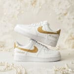 Custom hand-painted white Air Force 1 sneakers with gold accents for weddings.