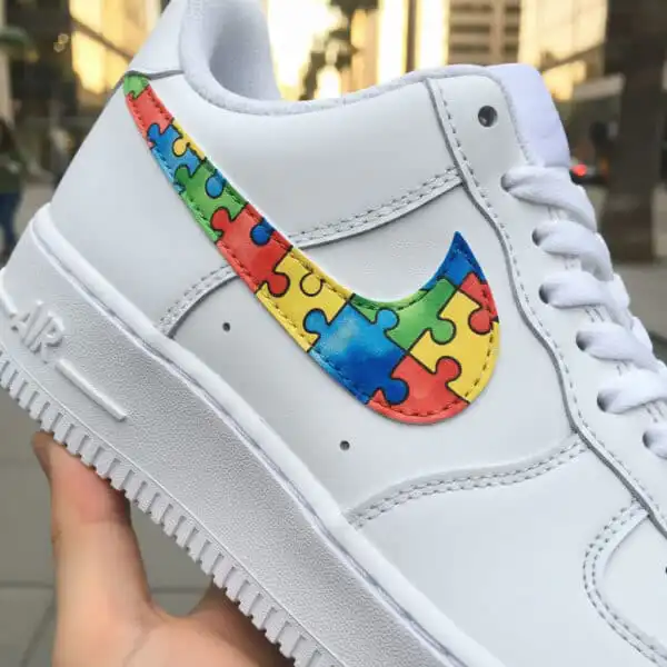 Custom hand-painted puzzle design on Nike Air Force 1 sneakers for unique style.