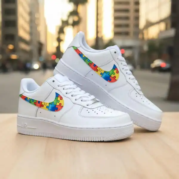 Custom hand-painted puzzle design on Air Force 1 sneakers for autism awareness.