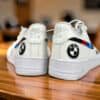 Custom hand-painted BMW Air Force 1 sneakers with BMW logo and M stripes.