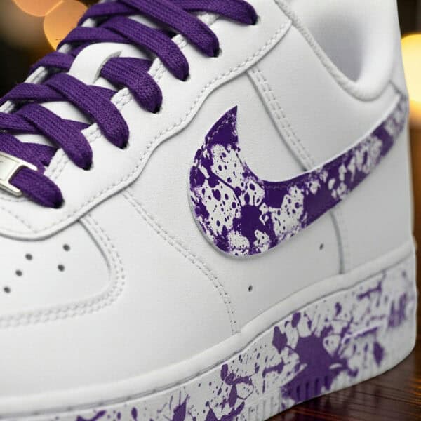 Custom hand-painted purple splash Nike Air Force 1 sneakers with unique design.