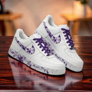 Air Force 1 sneakers with purple splash paint design and purple laces. Custom hand-painted footwear.