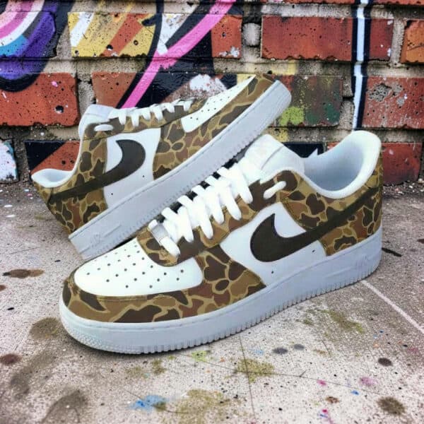 Air Force 1 sneakers with hand-painted duck camo design and black Nike swoosh. Unique, stylish, and.