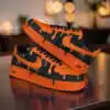 Hand-painted orange drip design on black Air Force 1 sneakers for a bold, artistic look.