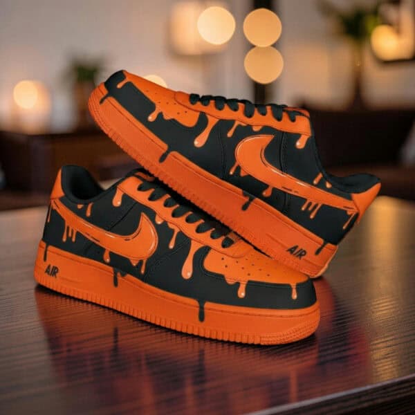 Hand-painted orange drip design on black Air Force 1 sneakers for a bold, artistic look.