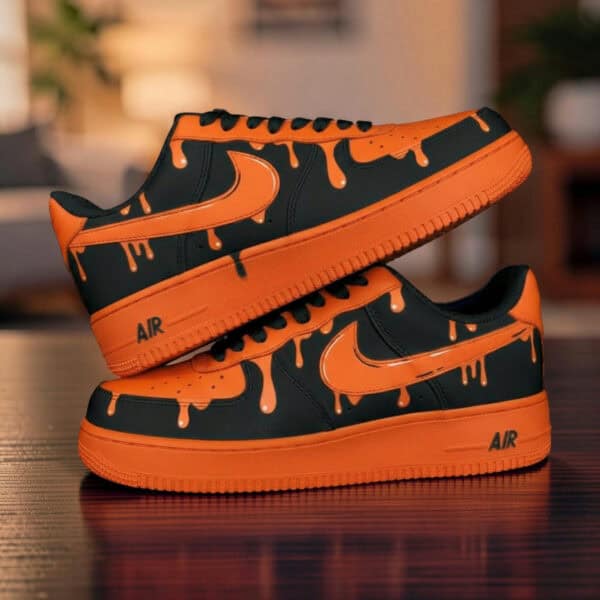 Custom orange drip Nike Air Force 1 sneakers with black accents and unique paint design.