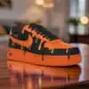 Custom orange drip Nike Air Force 1 sneakers with black accents, unique hand-painted design.