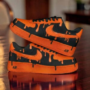 Custom painted orange drip Nike Air Force 1 sneakers for unique streetwear style.